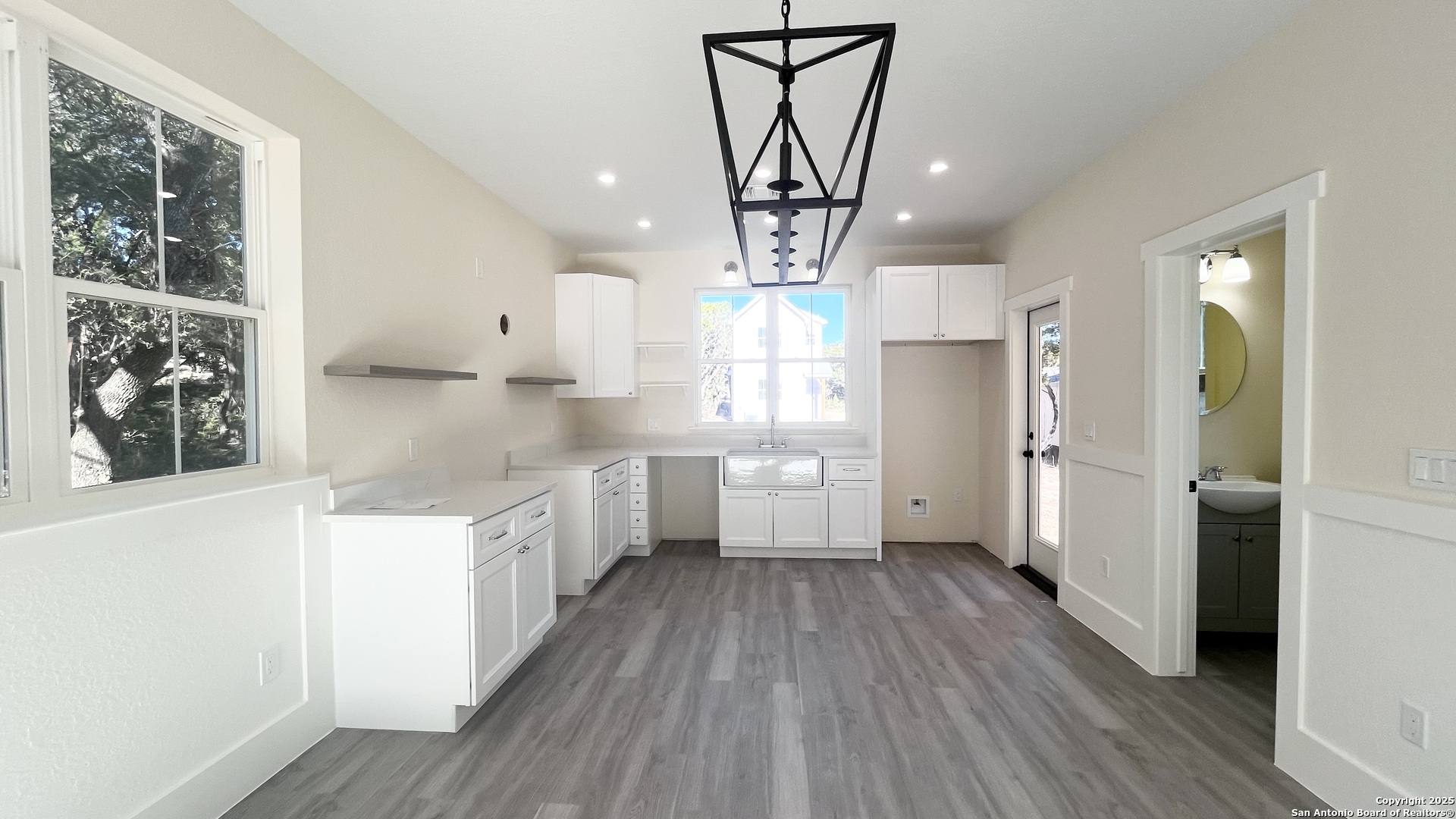 477 Scenic Drive Bandera, TX 78003 - Photo 7 of 22 a kitchen with stainless steel appliances a counter top space cabinets and wooden floor