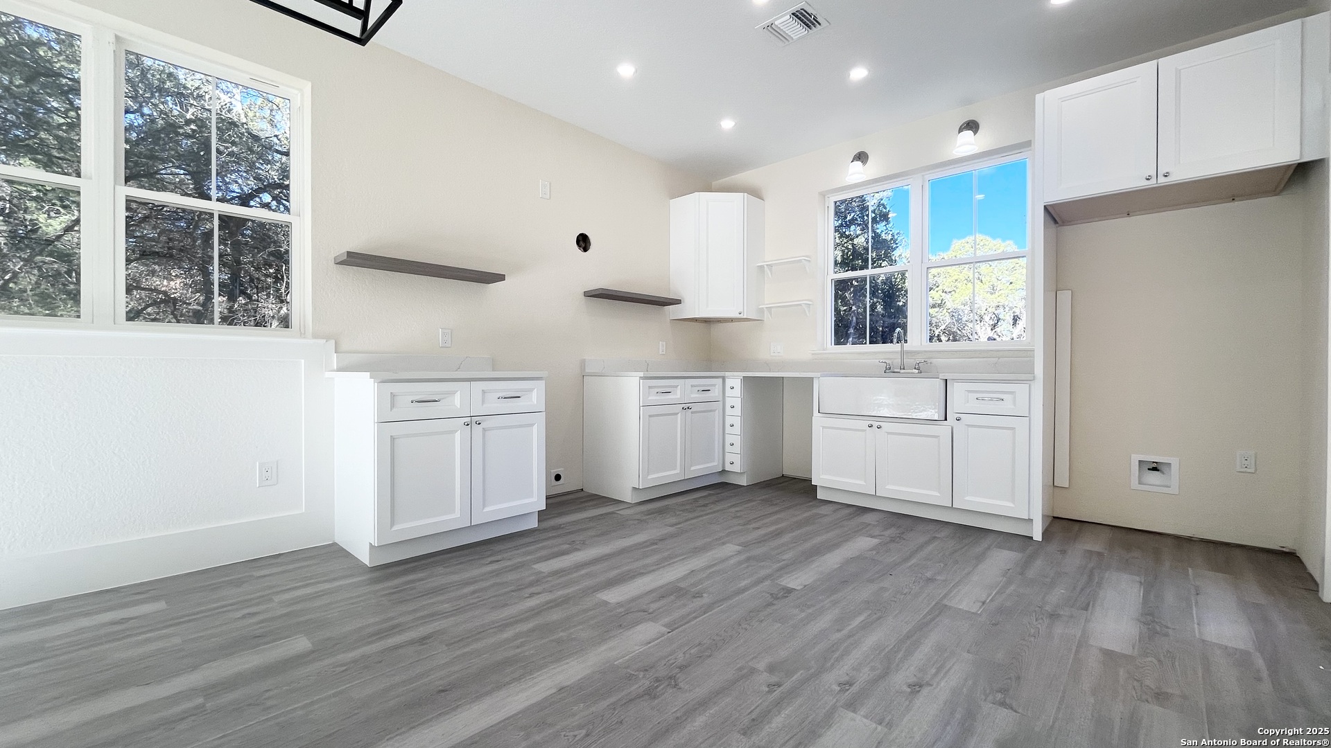 477 Scenic Drive Bandera, TX 78003 - Photo 8 of 22 a kitchen with white cabinets and white appliances