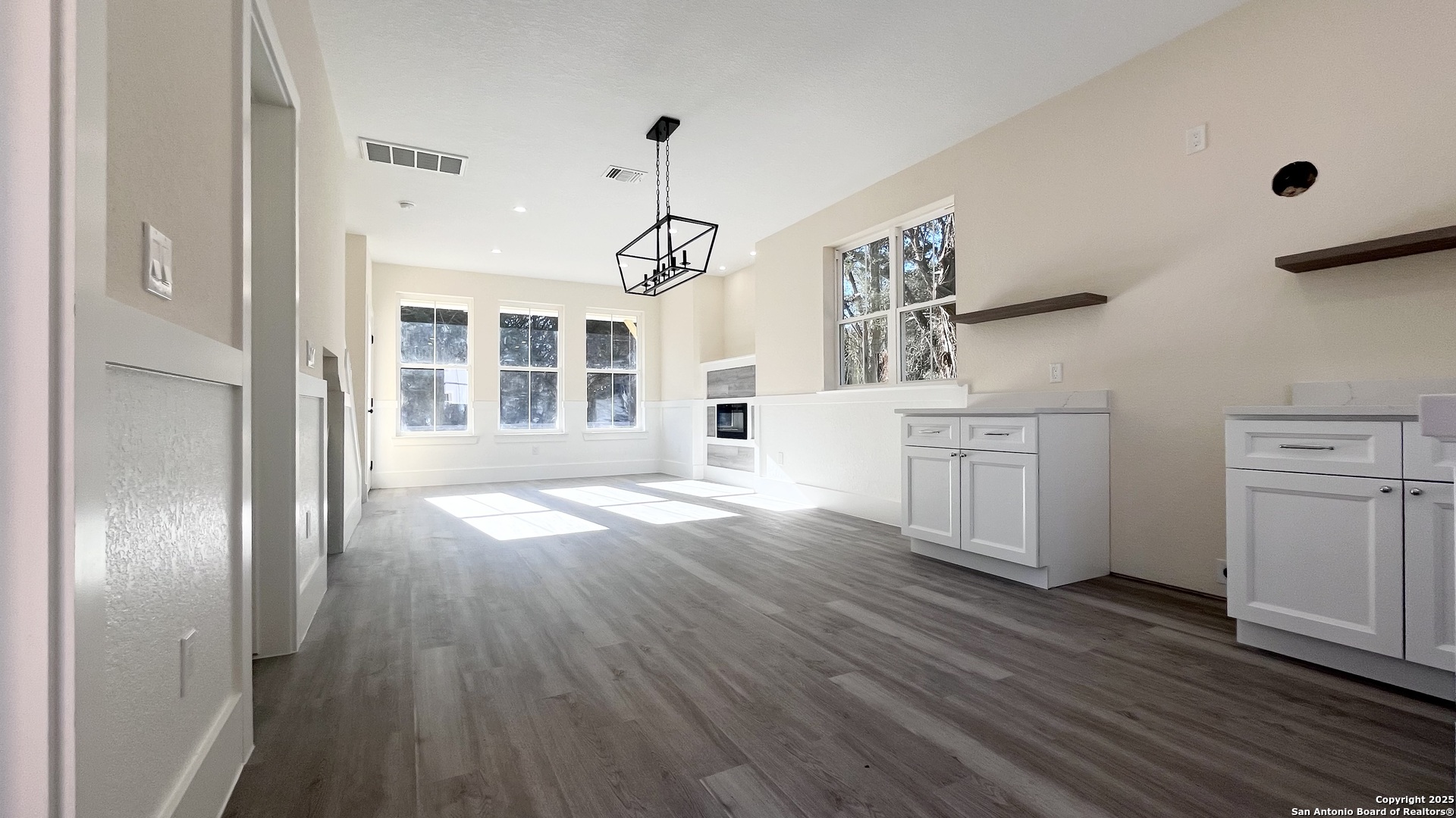 477 Scenic Drive Bandera, TX 78003 - Photo 9 of 22 a view of a kitchen with wooden floor and windows