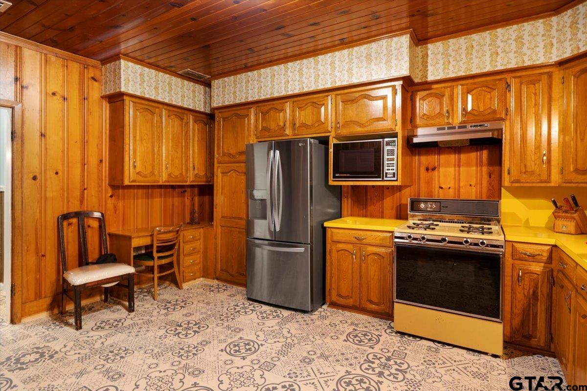 3109 West Shaw Street Tyler, TX 75701 - Photo 12 of 27 a kitchen with stainless steel appliances granite countertop a refrigerator and a stove top oven