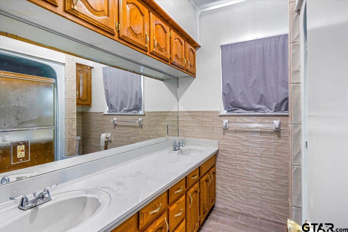 3109 West Shaw Street Tyler, TX 75701 - Photo 15 of 27 a bathroom with a sink and a mirror