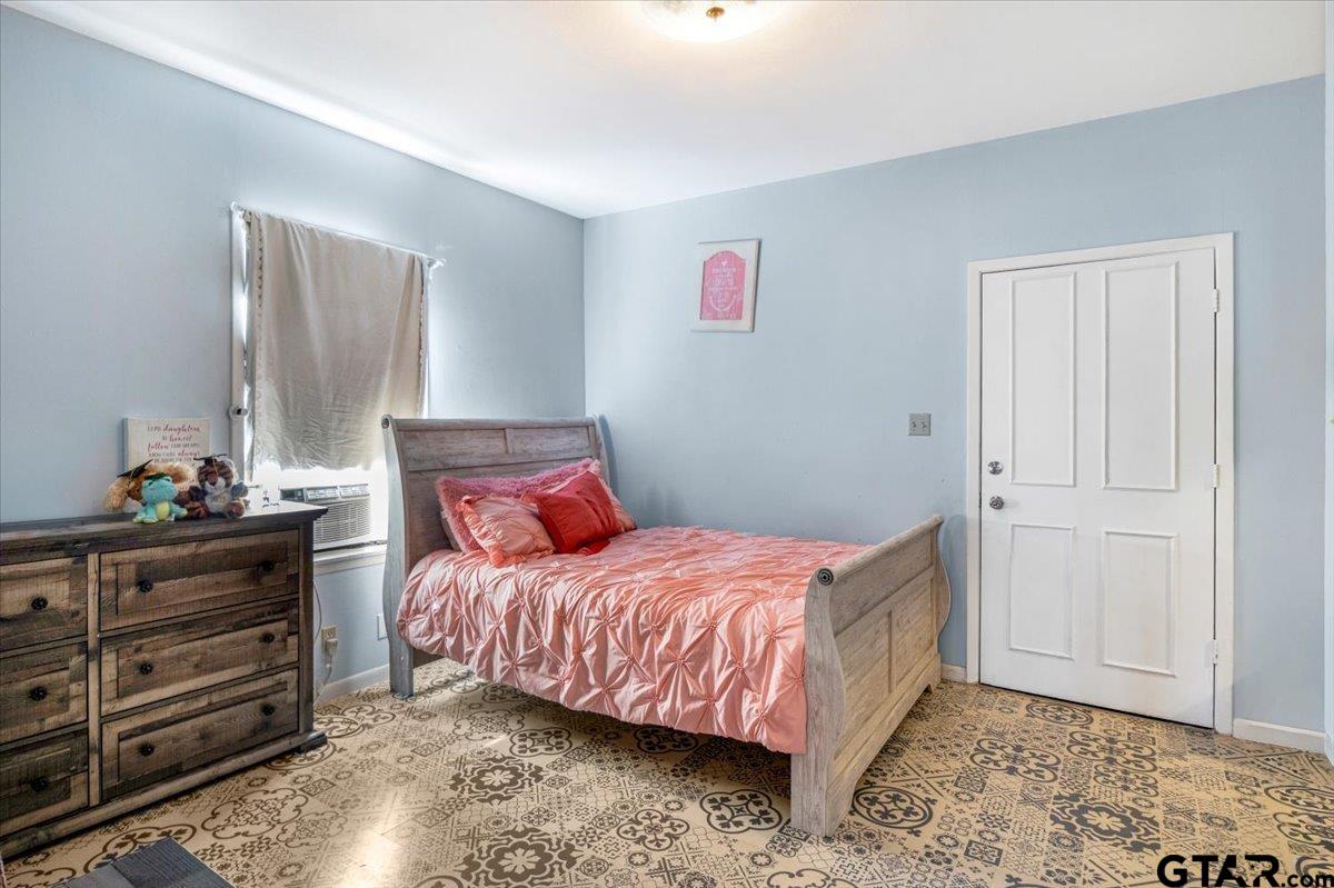 3109 West Shaw Street Tyler, TX 75701 - Photo 16 of 27 a bedroom with a bed and a dresser