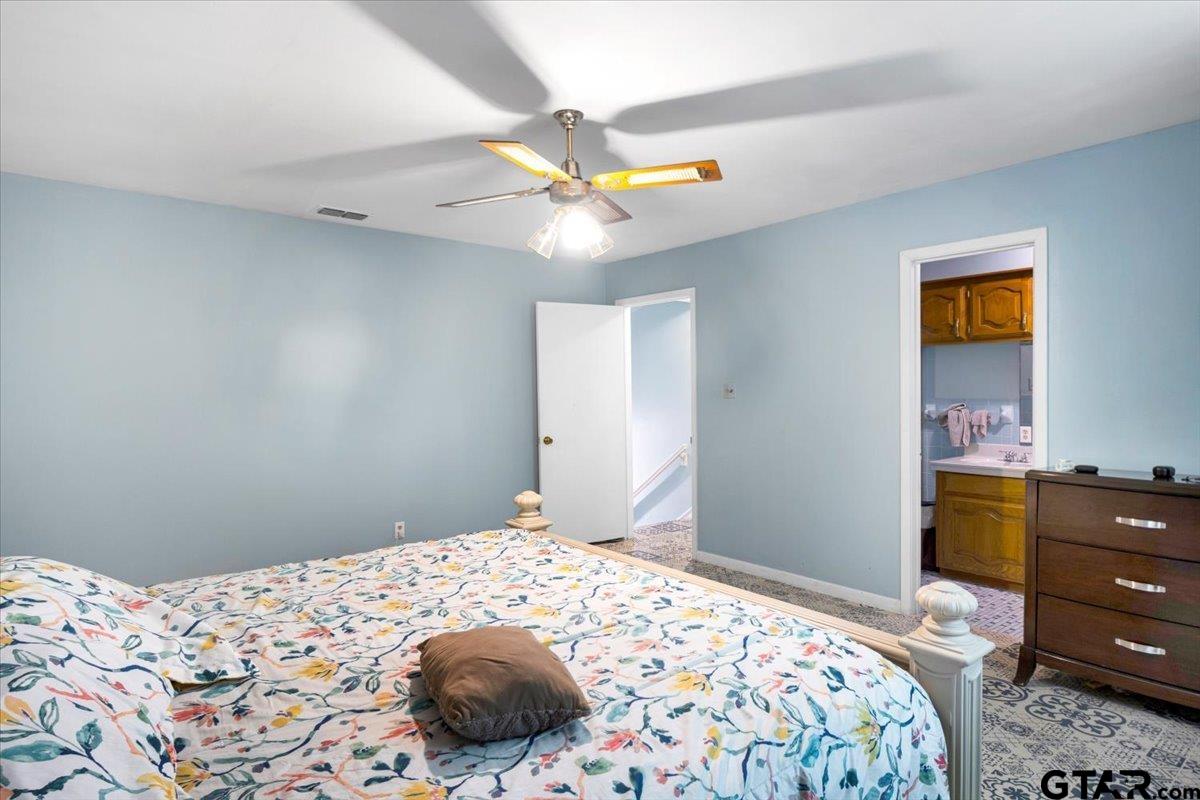 3109 West Shaw Street Tyler, TX 75701 - Photo 18 of 27 a bedroom with a bed and a dresser
