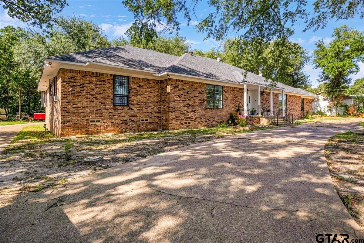 3109 West Shaw Street Tyler, TX 75701 - Photo 19 of 27 a front view of a house with a yard