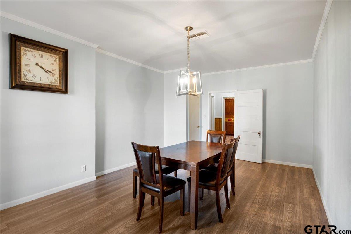 3109 West Shaw Street Tyler, TX 75701 - Photo 6 of 27 a view of a dining room with furniture wooden floor and chandelier