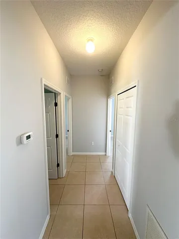 a view of a hallway to rooms