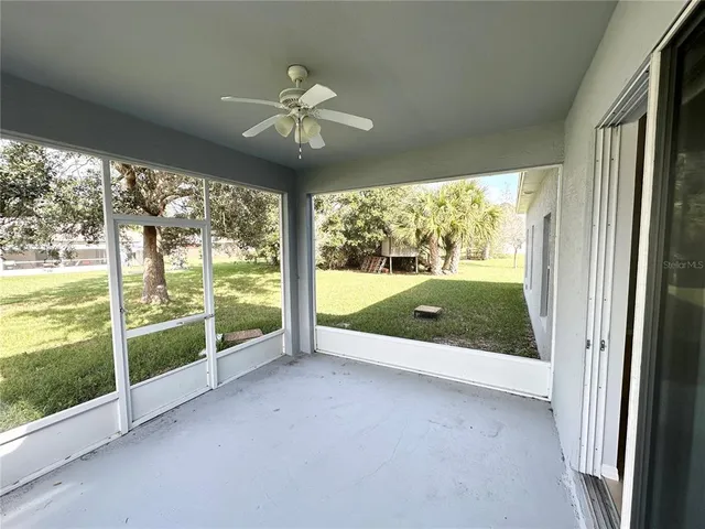 a view of an empty room with a fireplace and a large window