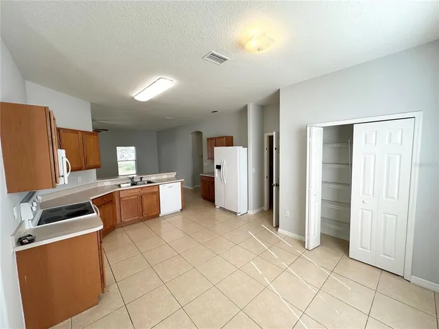 a kitchen with stainless steel appliances a refrigerator and a stove top oven