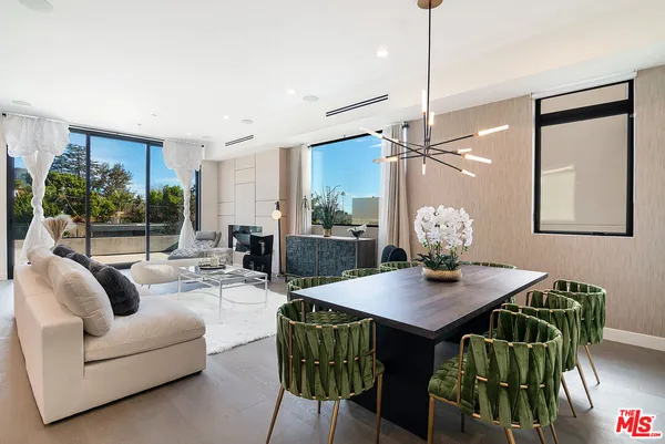 a living room with furniture a table and wooden floor
