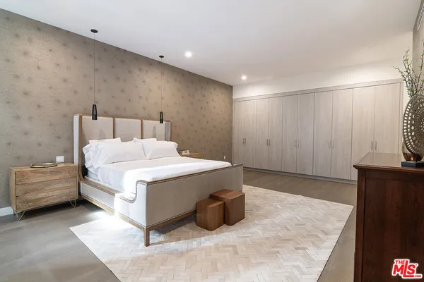 a spacious bedroom with a bed and a couch