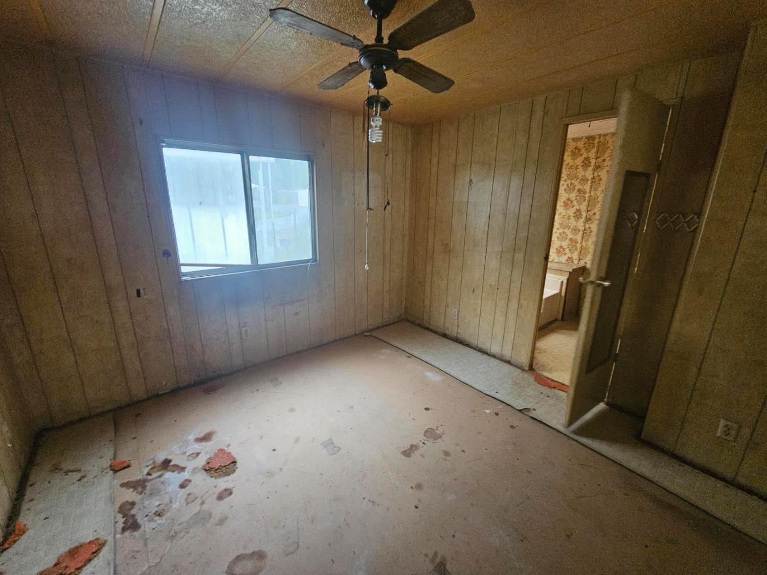 11705 Parey Avenue, Unit 16 Red Bluff, CA 96080 - Photo 3 of 12 an empty room with windows and closet