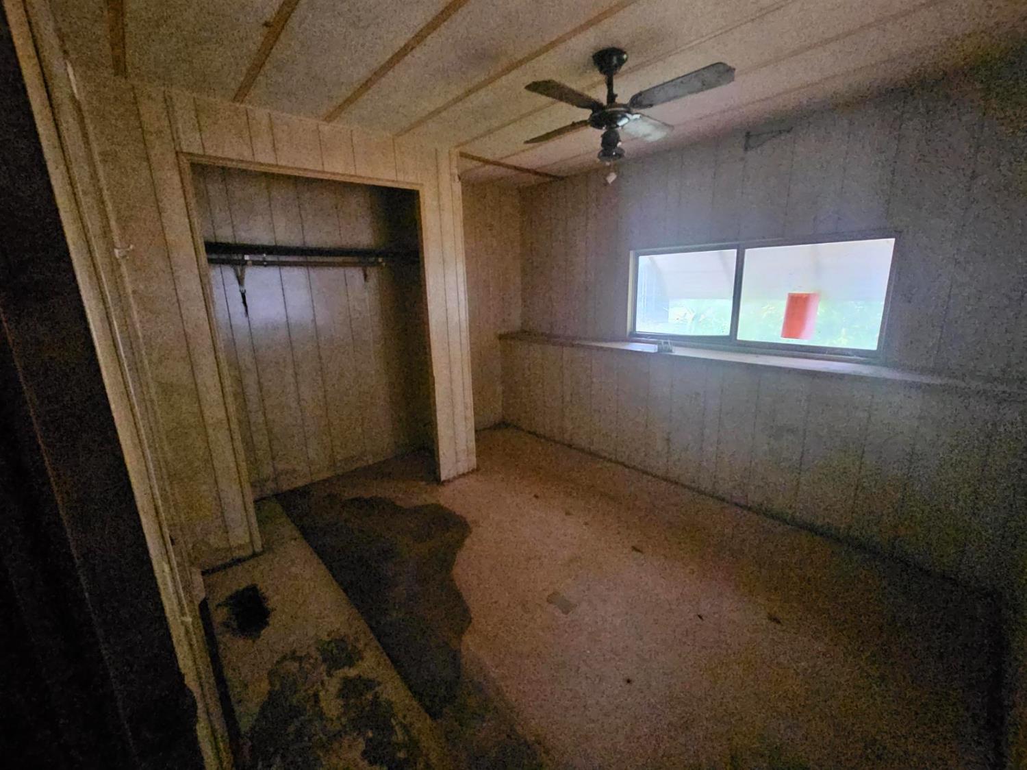 11705 Parey Avenue, Unit 16 Red Bluff, CA 96080 - Photo 4 of 12 an empty room with windows and fan
