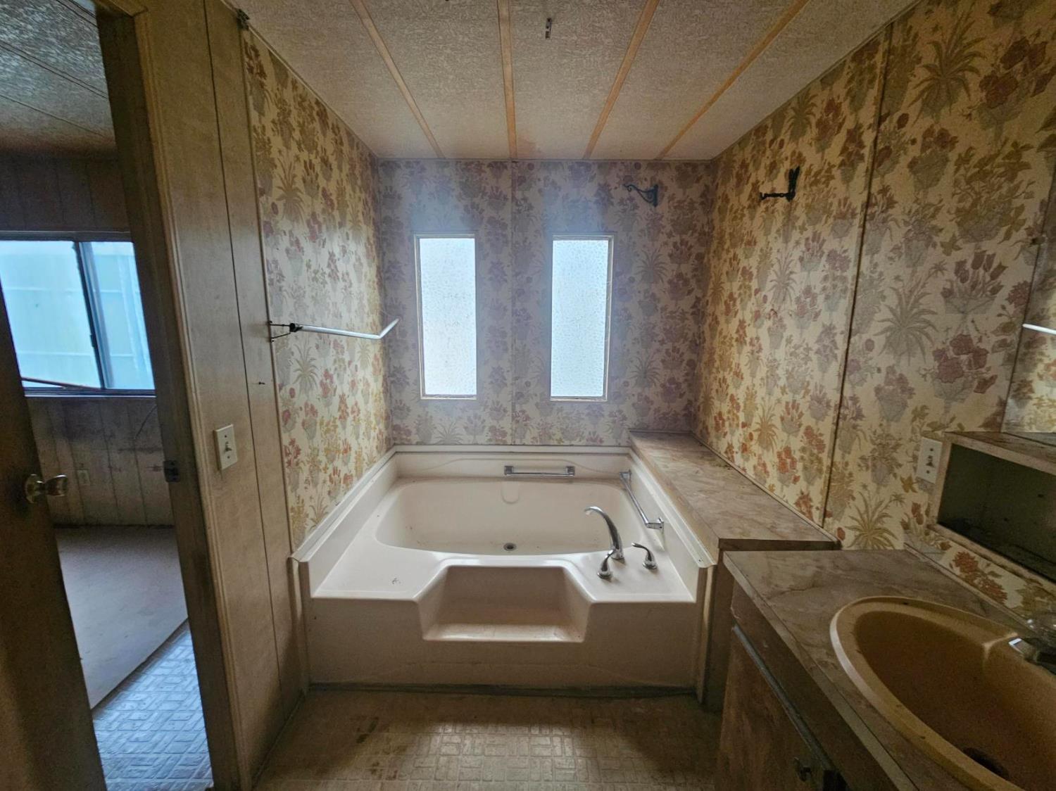 11705 Parey Avenue, Unit 16 Red Bluff, CA 96080 - Photo 9 of 12 a bathroom with a tub a sink and a shower