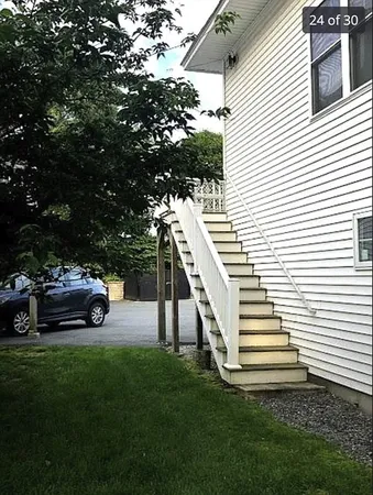 a view of a house with backyard and sitting area