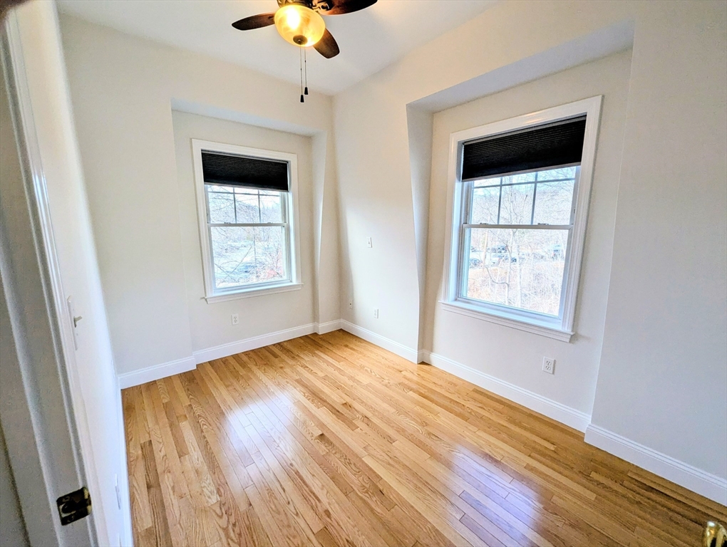 19 Railroad Street, Unit D2 Acton, MA 01720 - Photo 5 of 13 a view of an empty room with wooden floor and a window