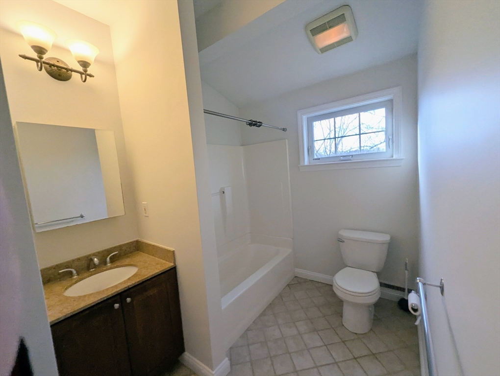 19 Railroad Street, Unit D2 Acton, MA 01720 - Photo 7 of 13 a bathroom with a granite countertop toilet and a sink