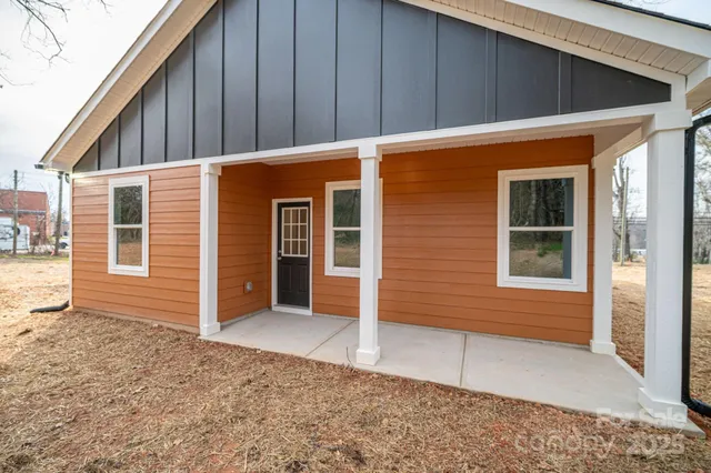 a backyard of a house with table and chairs
