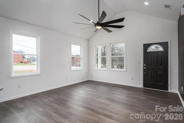 a living room with furniture a ceiling fan and a window