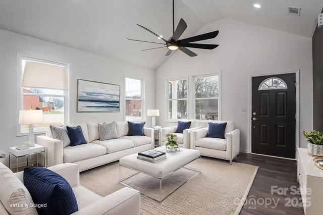 a living room with furniture a table and a window