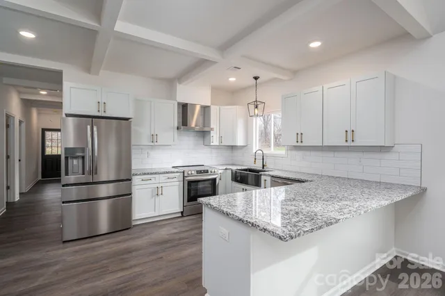 a kitchen with a sink window and cabinets