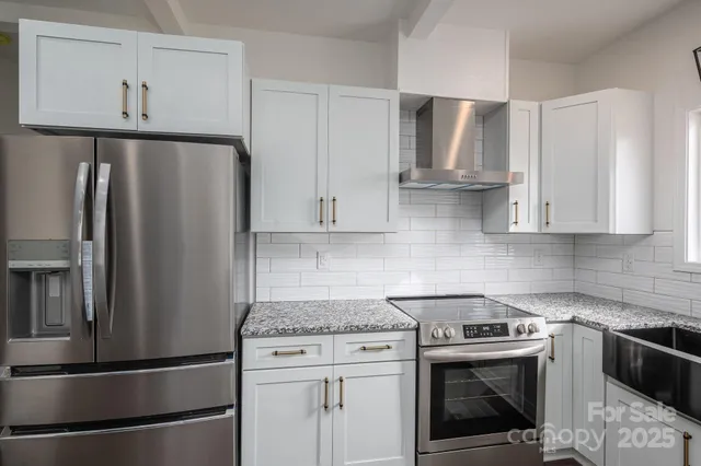 a kitchen with stainless steel appliances granite countertop a sink a stove and a granite counter tops