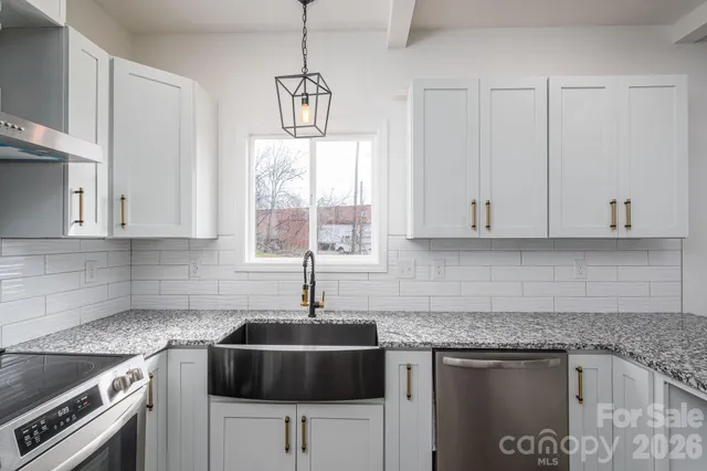 a bathroom with a granite countertop sink a mirror and a shower