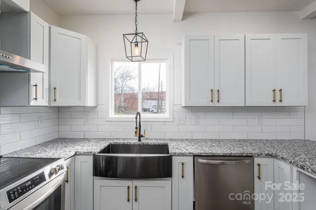 a bathroom with a granite countertop sink a large mirror and a shower