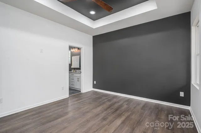 a bathroom with a granite countertop sink a toilet and a shower