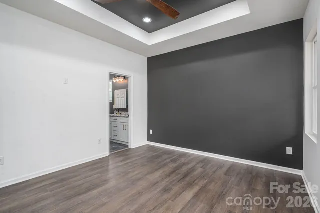 a bathroom with a granite countertop sink a toilet and a shower