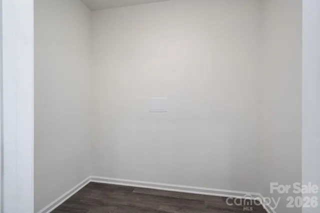 an empty room with wooden floor