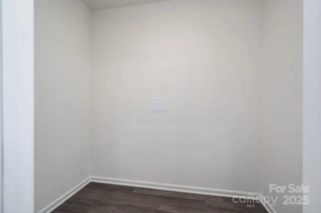 an empty room with wooden floor