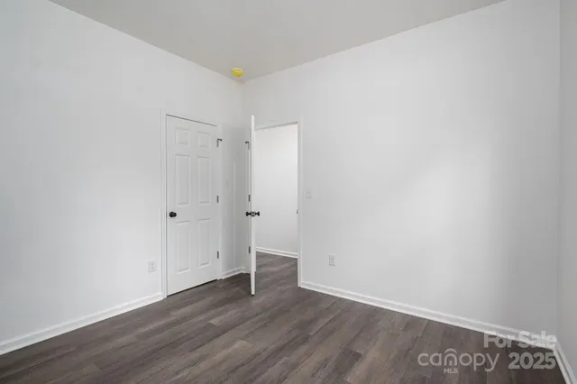 a bathroom with a granite countertop toilet a sink and a mirror