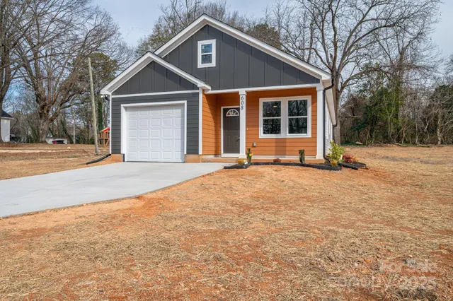 a house with yard and trees in the background