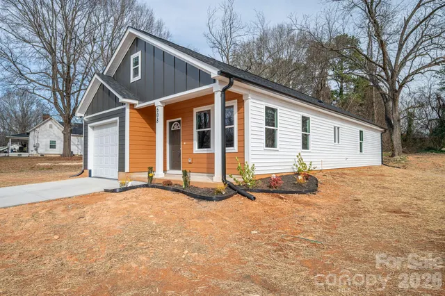 a view of a house with snow on the road