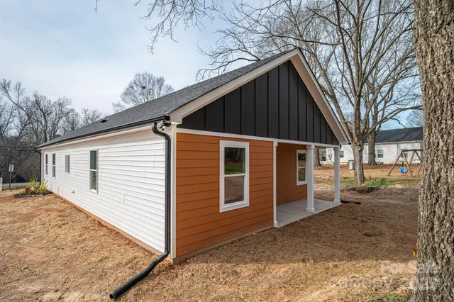 a view of a house with a yard covered in snow