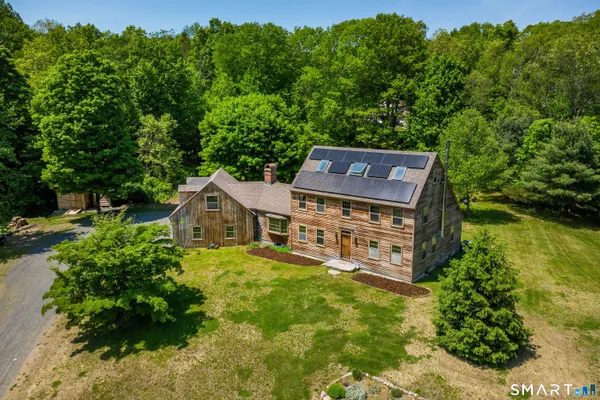an aerial view of a house with a yard