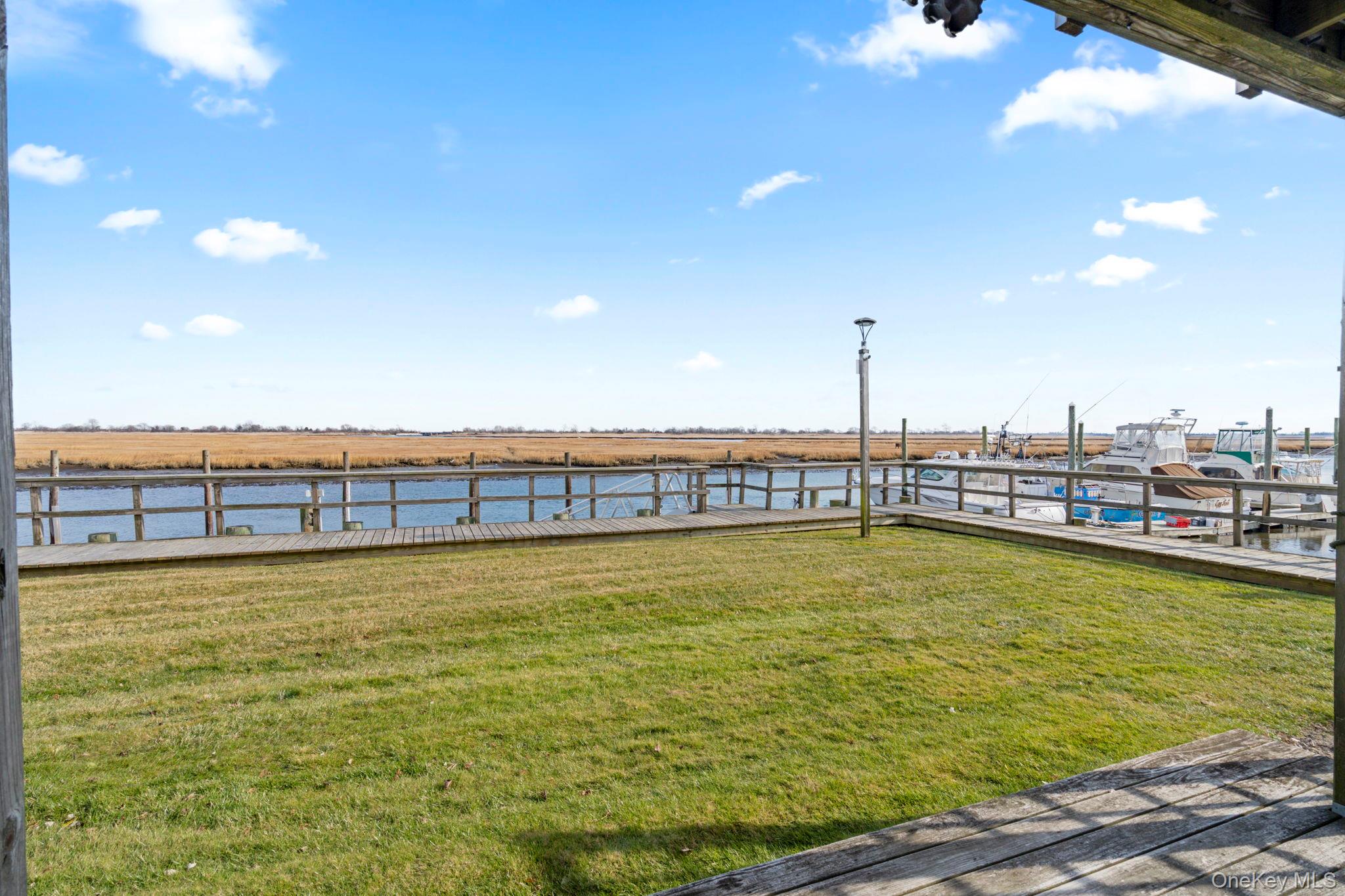 1 Anchorage Way, Unit 101 Freeport, NY 11520 - Photo 16 of 31 a view of a swimming pool and an outdoor seating