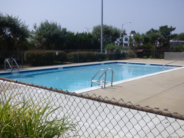 1 Anchorage Way, Unit 101 Freeport, NY 11520 - Photo 19 of 31 a view of a swimming pool with a chair