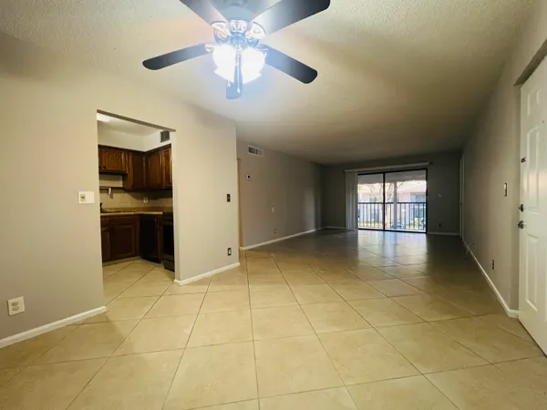a view of a porch with furniture and floor to ceiling window