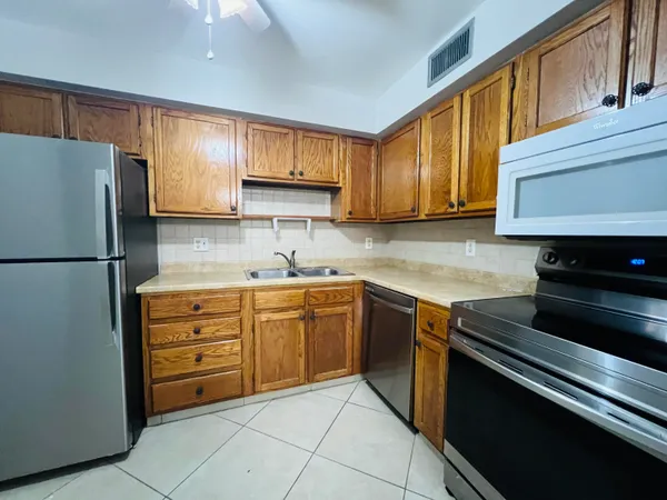 a kitchen with granite countertop cabinets and steel stainless steel appliances