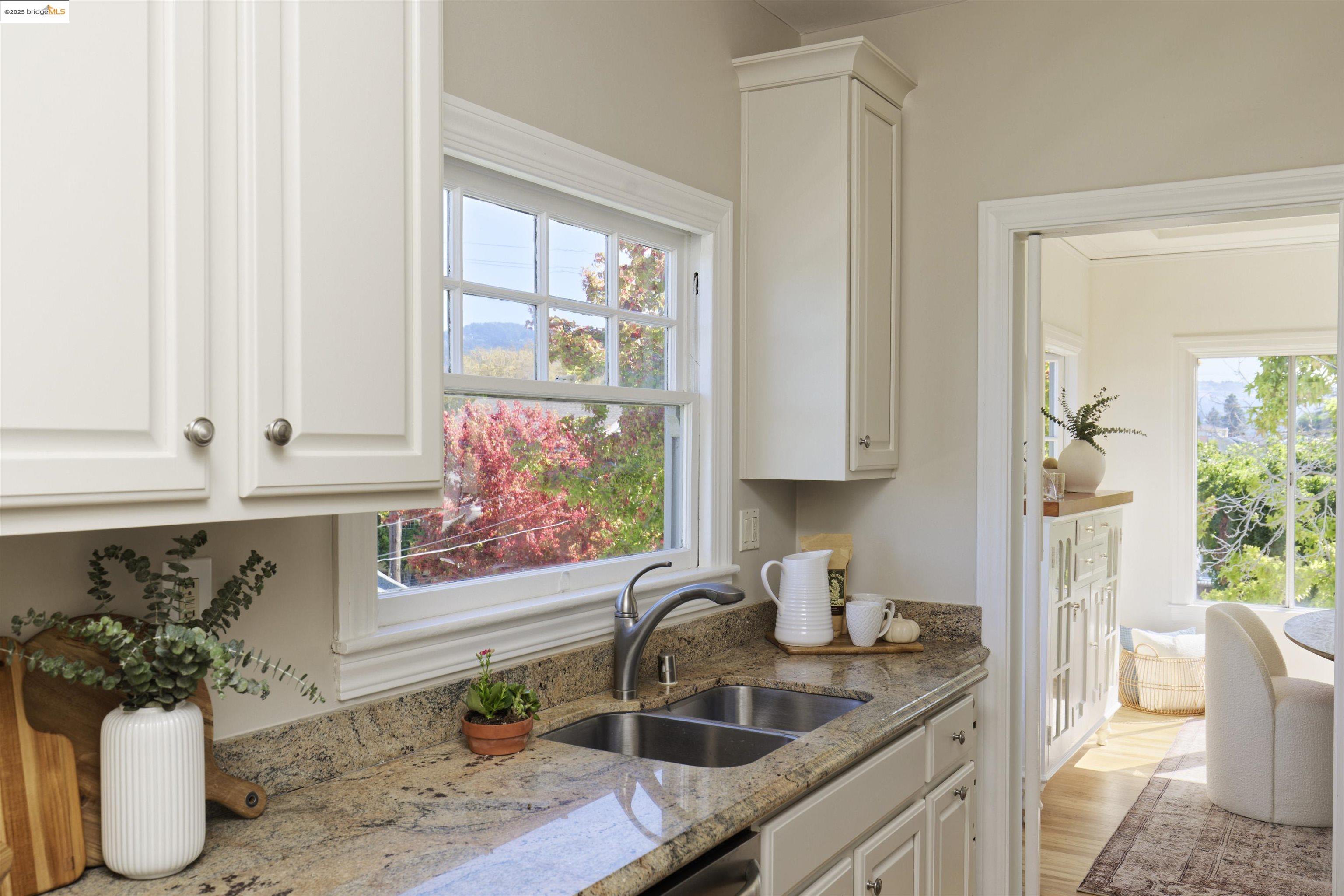 3945 Randolph Avenue, Unit 2 Oakland, CA 94602 - Photo 14 of 43 a kitchen with stainless steel appliances granite countertop a sink a stove and a window