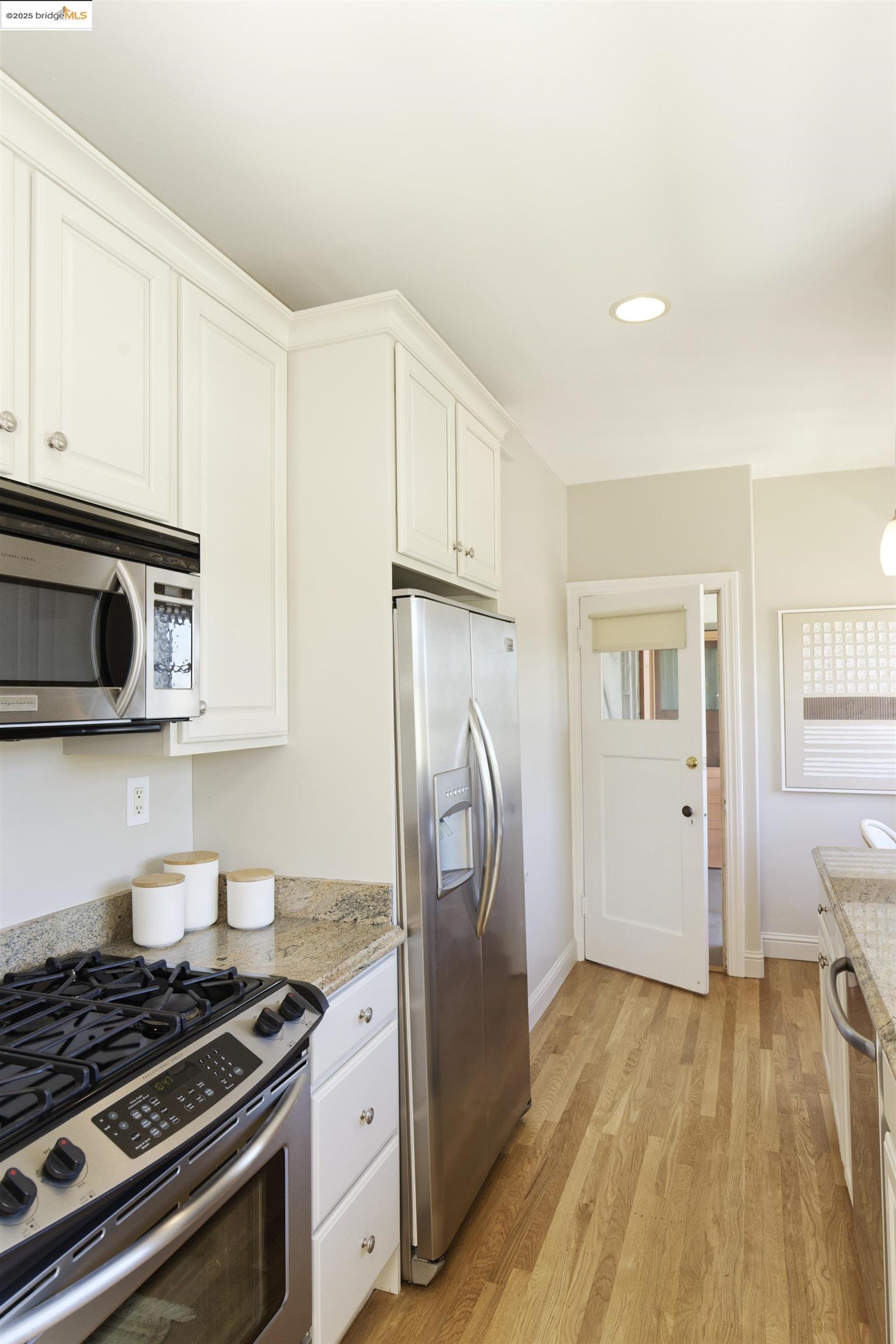 3945 Randolph Avenue, Unit 2 Oakland, CA 94602 - Photo 17 of 43 a kitchen with stainless steel appliances granite countertop a stove and a refrigerator
