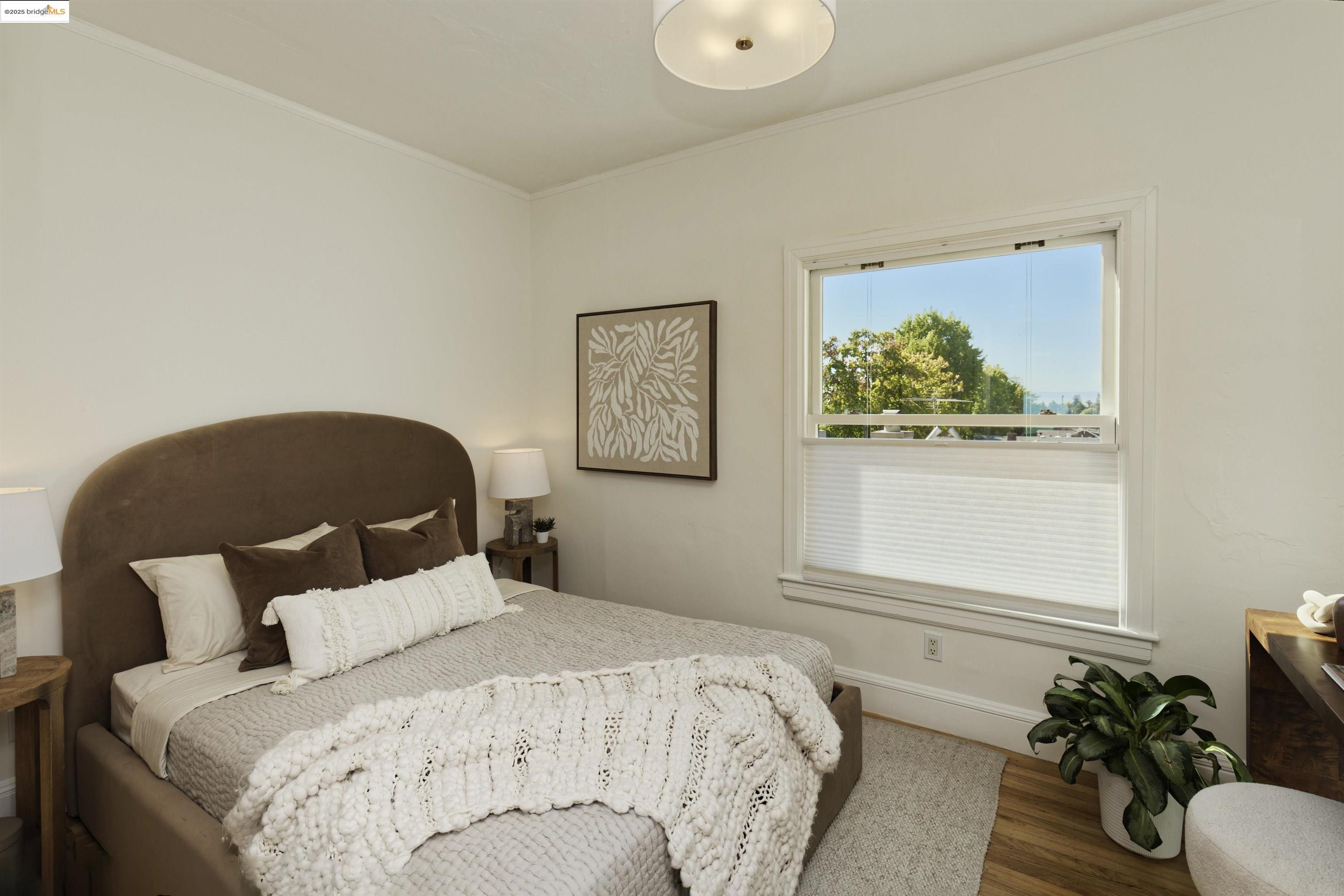 3945 Randolph Avenue, Unit 2 Oakland, CA 94602 - Photo 22 of 43 a bedroom with bed and wooden floor