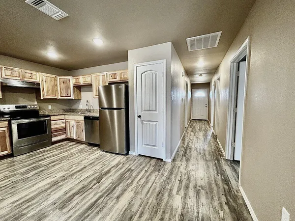 a kitchen with stainless steel appliances granite countertop a refrigerator oven a sink and dishwasher