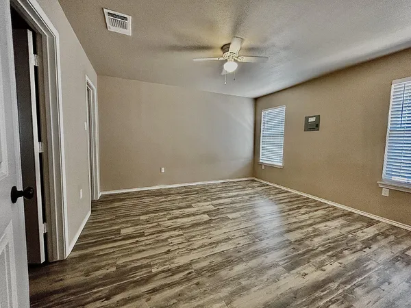 a view of a livingroom with wooden floor and window