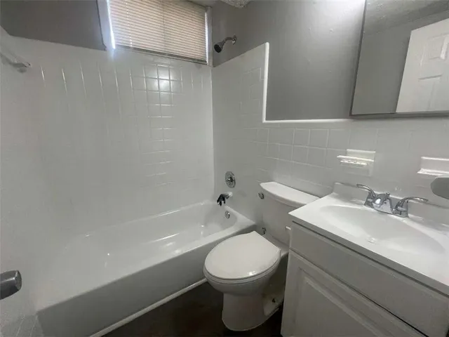 a bathroom with a toilet a sink and bathtub