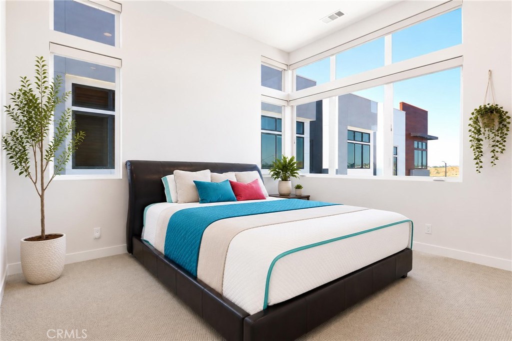253 Waypoint Tustin, CA 92782 - Photo 33 of 56 master bedroom with tall ceilings and windows to take in breathtaking sunsets or close the Hunter Douglas automatic blinds for privacy