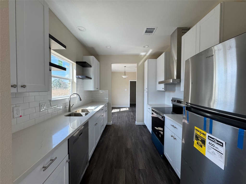 50 Westlake West Trinity, TX 75862 - Photo 5 of 23 a kitchen with stainless steel appliances a sink cabinets and wooden floor