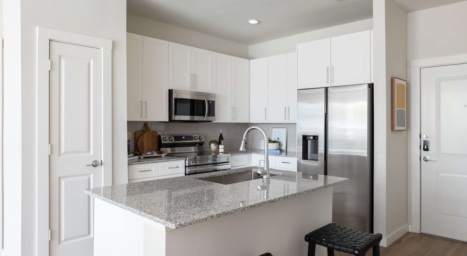 19101 Town Ridge Lane, Unit 4106 Webster, TX 77598 - Photo 3 of 30 a kitchen with a refrigerator and a sink