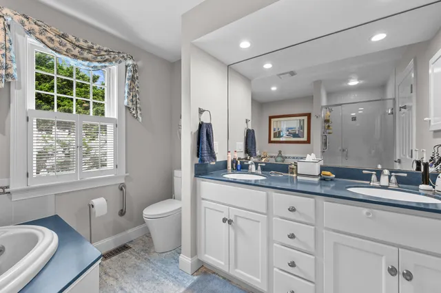 a bathroom with a sink tub and a mirror